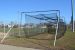 Practice net next to baseball field.